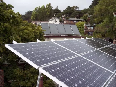 A rooftop equipped with modern solar panels under a bright sun.