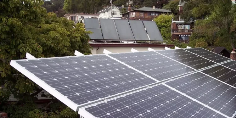 A rooftop equipped with modern solar panels under a bright sun.